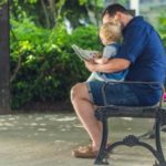 father-reading-to-daughter_925x