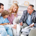 Young couple with children meeting with  Insurance Agent.